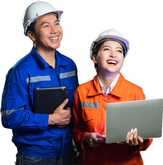 Two Asian men and a woman, equipped with hard hats and safety glasses, engage with a laptop in a construction environment.